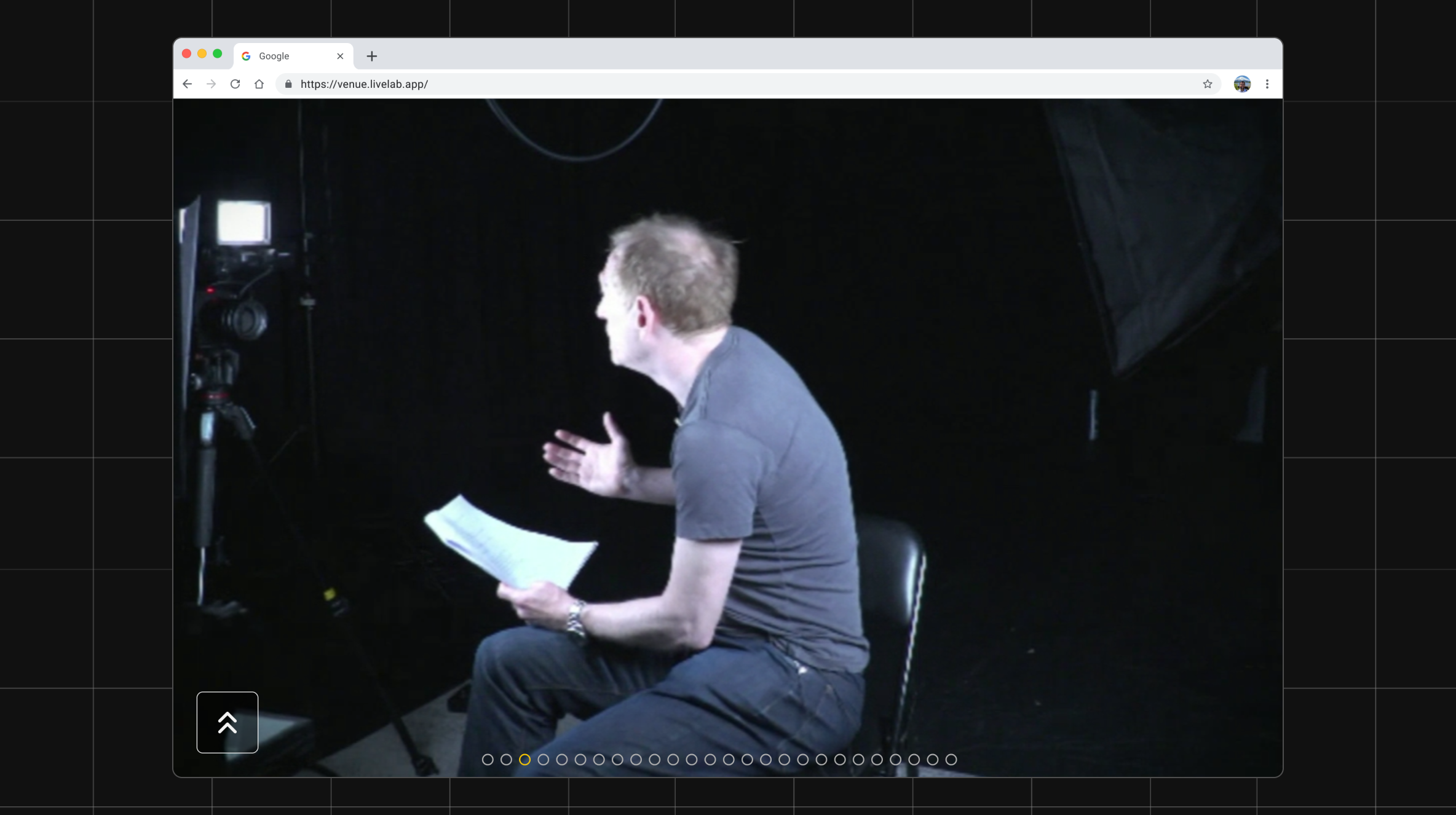 Broadcast footage of a performer seated, speaking to camera